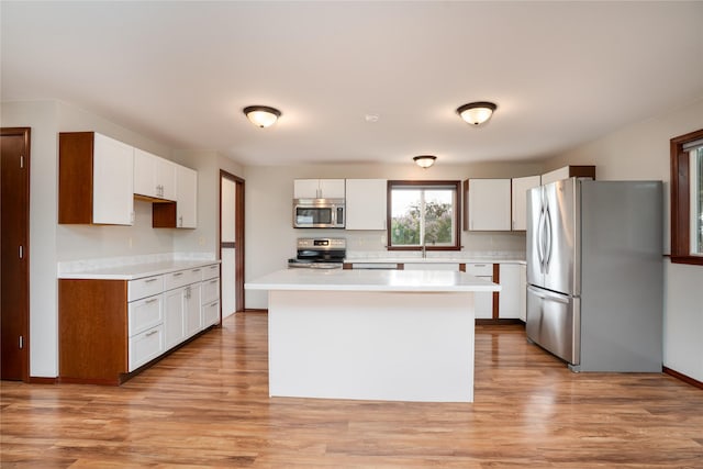 413 S Oak St, Townsend, MT 59644 - kitchen with stainless steel appliances, light countertops, a center island, and light wood-type flooring