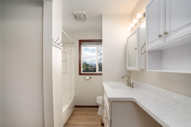 413 S Oak St, Townsend, MT 59644 - full bath featuring vanity, toilet, wood finished floors, baseboards, and shower / bath combination