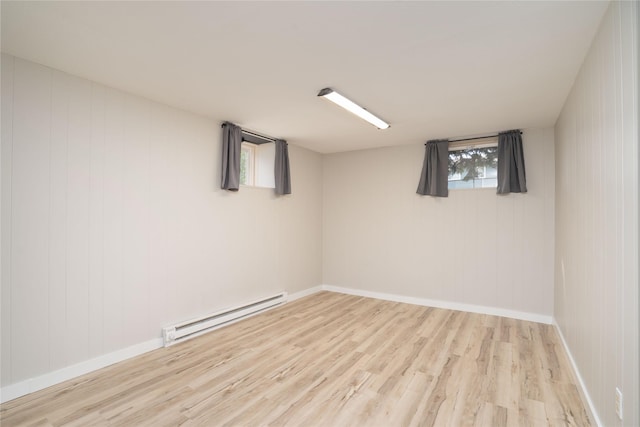 413 S Oak St, Townsend, MT 59644 - below grade area with a baseboard heating unit, wood finished floors, and baseboards