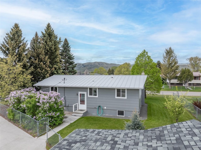 413 S Oak St, Townsend, MT 59644 - back of property featuring a mountain view, a chimney, a patio, and metal roof