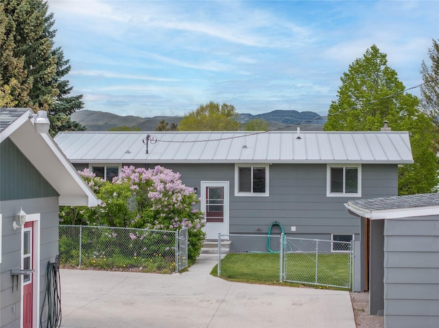413 S Oak St, Townsend, MT 59644 - rear view of property with a mountain view, metal roof, and a chimney