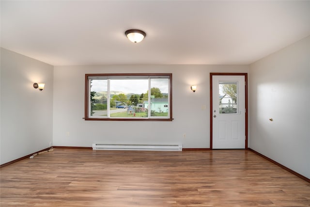 413 S Oak St, Townsend, MT 59644 - foyer entrance with a baseboard heating unit, plenty of natural light, light wood-style flooring, and baseboards