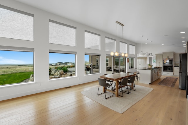 4910 Lauryn Ct, Helena, MT 59602 - dining area featuring healthy amount of natural light, recessed lighting, a high ceiling, and light wood-style floors
