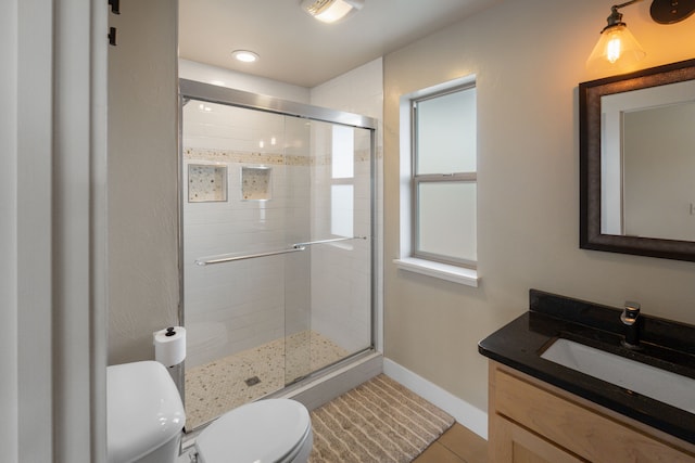 4910 Lauryn Ct, Helena, MT 59602 - full bath with toilet, vanity, a shower stall, baseboards, and tile patterned flooring