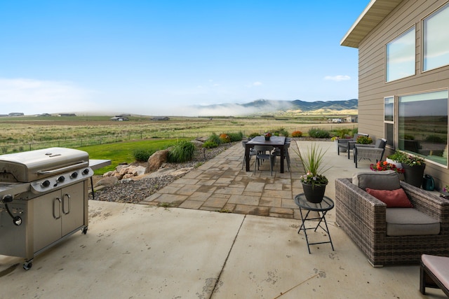 4910 Lauryn Ct, Helena, MT 59602 - view of patio featuring outdoor dining space, grilling area, a rural view, and a mountain view