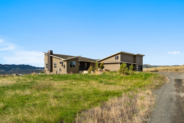 4910 Lauryn Ct, Helena, MT 59602 - view of side of home with a chimney and a mountain view