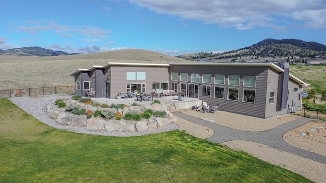 4910 Lauryn Ct, Helena, MT 59602 - back of property with a mountain view and a patio