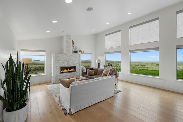4910 Lauryn Ct, Helena, MT 59602 - living area featuring a fireplace, light wood finished floors, recessed lighting, a high ceiling, and baseboards