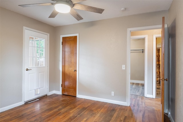 2109 S 5th St W, Missoula, MT 59801 - unfurnished bedroom featuring dark wood finished floors, baseboards, and ceiling fan