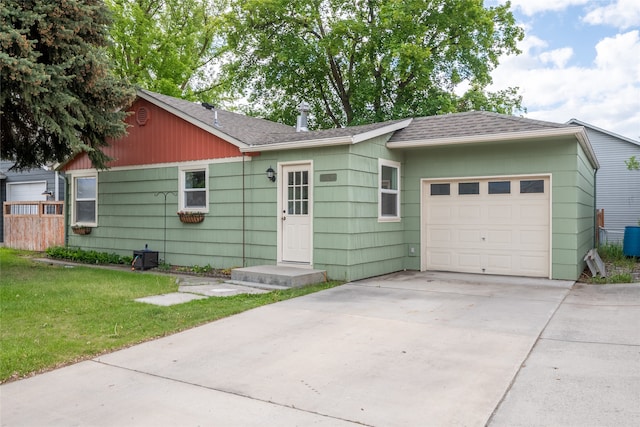 2109 S 5th St W, Missoula, MT 59801 - ranch-style house featuring an attached garage, a shingled roof, driveway, and a front yard