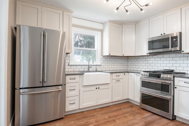 2109 S 5th St W, Missoula, MT 59801 - kitchen with stainless steel appliances, a sink, dark stone counters, and decorative backsplash