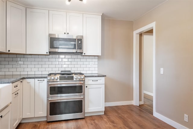 2109 S 5th St W, Missoula, MT 59801 - kitchen featuring stainless steel appliances, decorative backsplash, baseboards, and ornamental molding