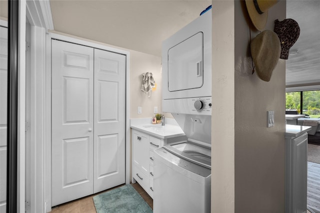 180 Vista Ln Unit 152, Bigfork, MT 59911 - laundry room featuring stacked washer and clothes dryer and tile patterned flooring