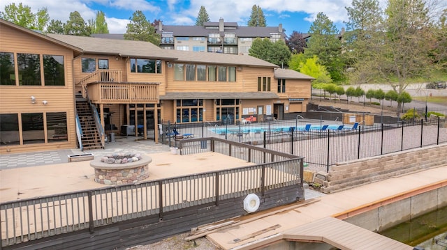 180 Vista Ln Unit 152, Bigfork, MT 59911 - view of pool with a fire pit, stairway, a wooden deck, and a patio