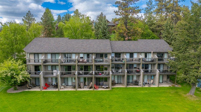 180 Vista Ln Unit 152, Bigfork, MT 59911 - rear view of house with a patio area and a lawn