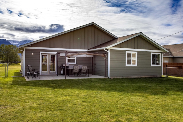 435 6th Ave NW, Ronan, MT 59864 - rear view of property with a patio area, board and batten siding, and french doors