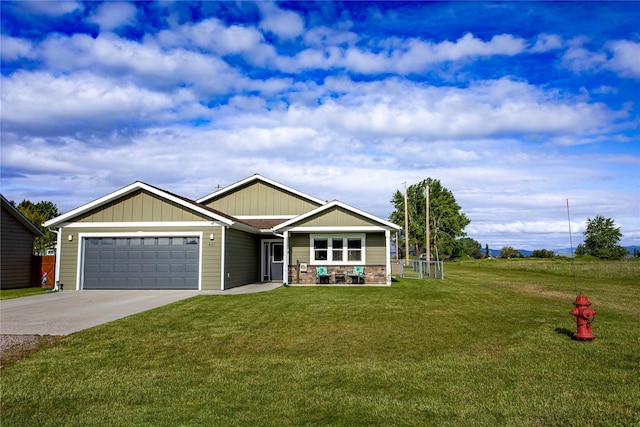 435 6th Ave NW, Ronan, MT 59864 - view of front of property with a garage, driveway, a front yard, and board and batten siding