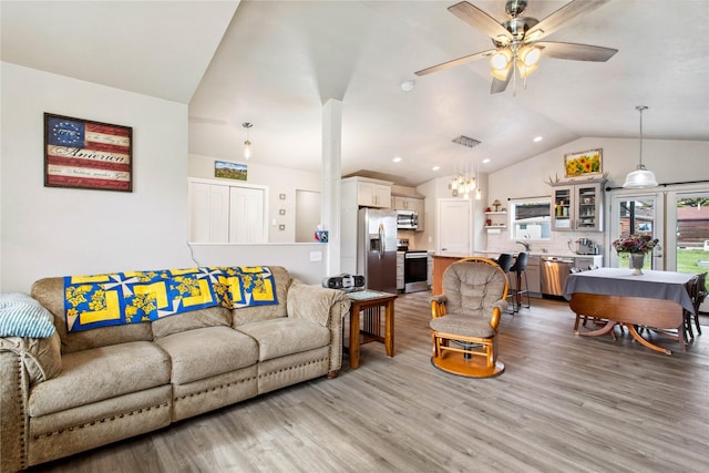 435 6th Ave NW, Ronan, MT 59864 - living area featuring vaulted ceiling, light wood-style flooring, a ceiling fan, and a chandelier