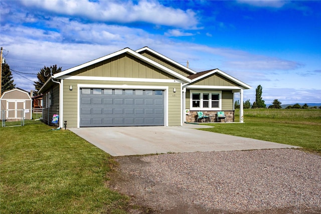 435 6th Ave NW, Ronan, MT 59864 - view of front of home with driveway, a front yard, board and batten siding, and an attached garage