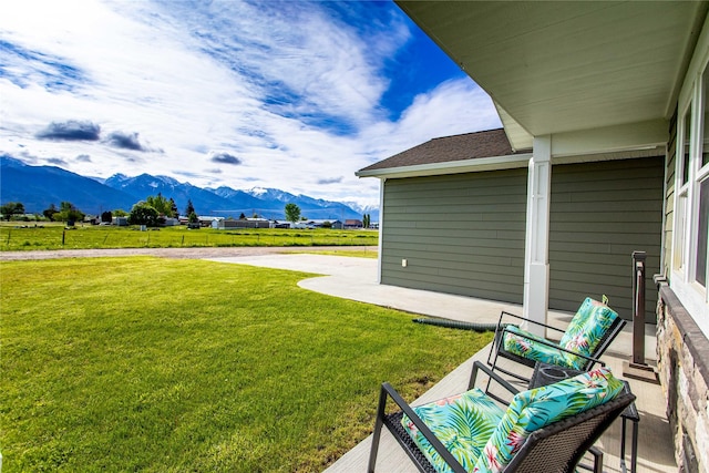 435 6th Ave NW, Ronan, MT 59864 - view of grassy yard with a mountain view and a patio area