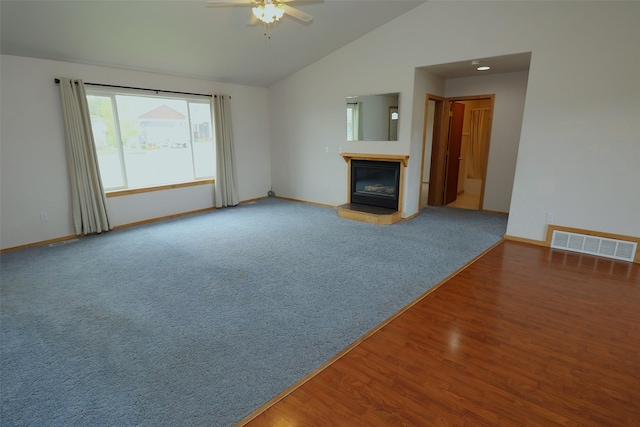 506 Centennial Dr, Sheridan, MT 59749 - unfurnished living room with a glass covered fireplace, lofted ceiling, baseboards, ceiling fan, and wood finished floors