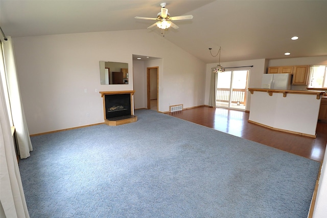 506 Centennial Dr, Sheridan, MT 59749 - unfurnished living room featuring carpet floors, baseboards, ceiling fan, lofted ceiling, and a fireplace with raised hearth