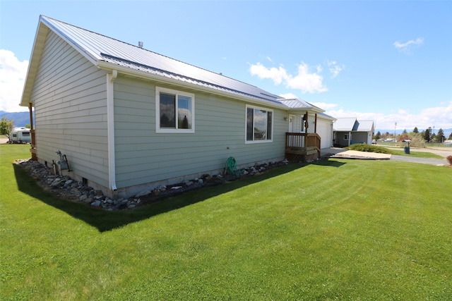 506 Centennial Dr, Sheridan, MT 59749 - view of side of home with a lawn and metal roof