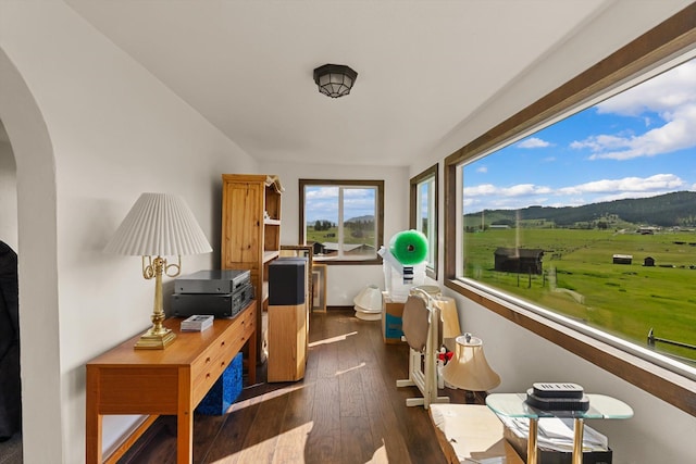 209 Caps Rd, Kalispell, MT 59901 - office area featuring arched walkways, dark wood-style flooring, and a mountain view