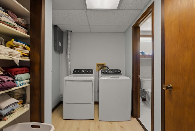209 Caps Rd, Kalispell, MT 59901 - laundry area featuring light wood-style floors, washing machine and clothes dryer, and electric panel