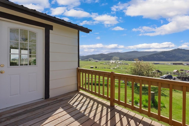 209 Caps Rd, Kalispell, MT 59901 - wooden terrace featuring a mountain view, a yard, and a rural view