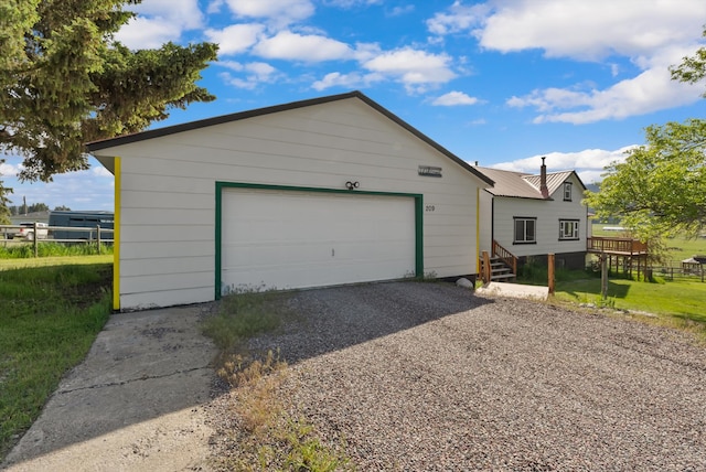 209 Caps Rd, Kalispell, MT 59901 - view of front facade with a garage and gravel driveway