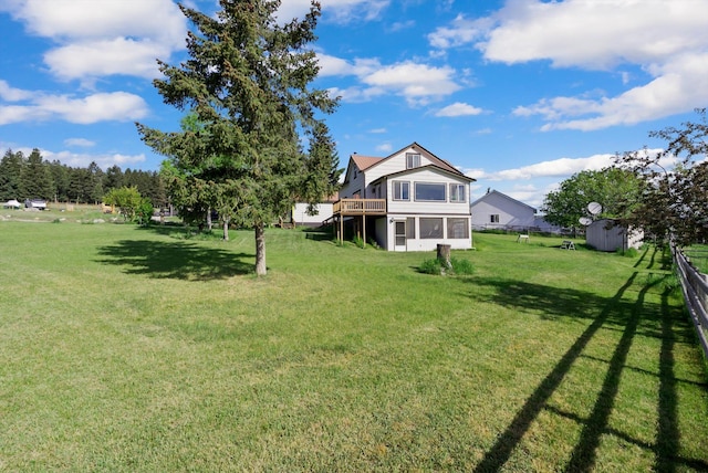 209 Caps Rd, Kalispell, MT 59901 - view of grassy yard featuring a sunroom and a storage shed