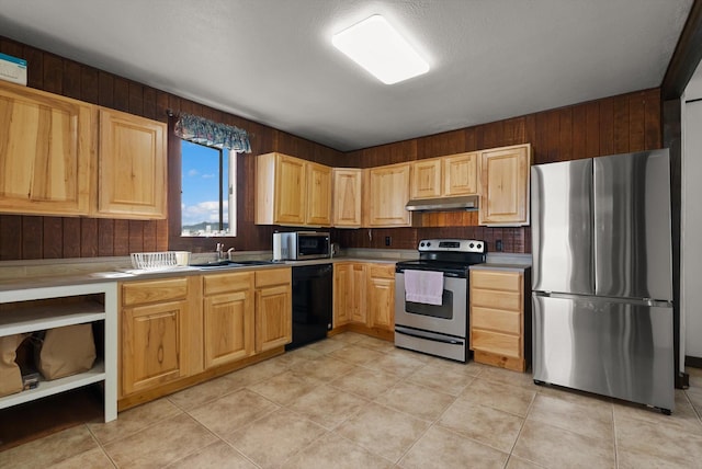 209 Caps Rd, Kalispell, MT 59901 - kitchen featuring stainless steel appliances, under cabinet range hood, light brown cabinetry, and light tile patterned flooring