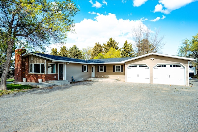 3495 Juniper Dr, Helena, MT 59602 - ranch-style house featuring a chimney, driveway, and a garage