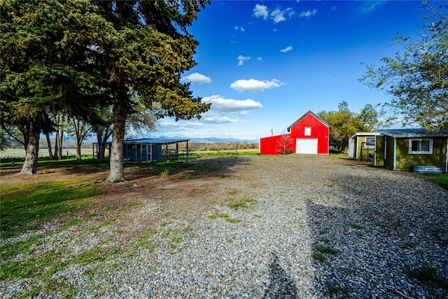 3495 Juniper Dr, Helena, MT 59602 - view of yard with an outbuilding, driveway, and a garage