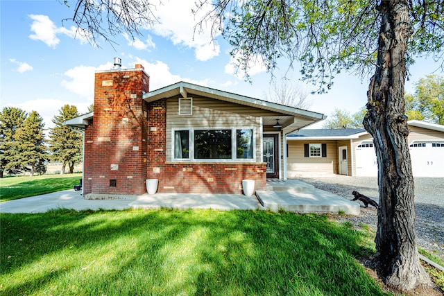 3495 Juniper Dr, Helena, MT 59602 - view of front of property with a garage, a front yard, brick siding, and a chimney
