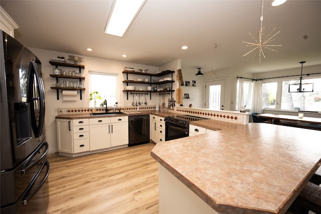 3495 Juniper Dr, Helena, MT 59602 - kitchen with black appliances, open shelves, a sink, a peninsula, and recessed lighting