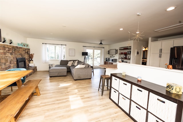 3495 Juniper Dr, Helena, MT 59602 - living area featuring light wood finished floors, a stone fireplace, and recessed lighting