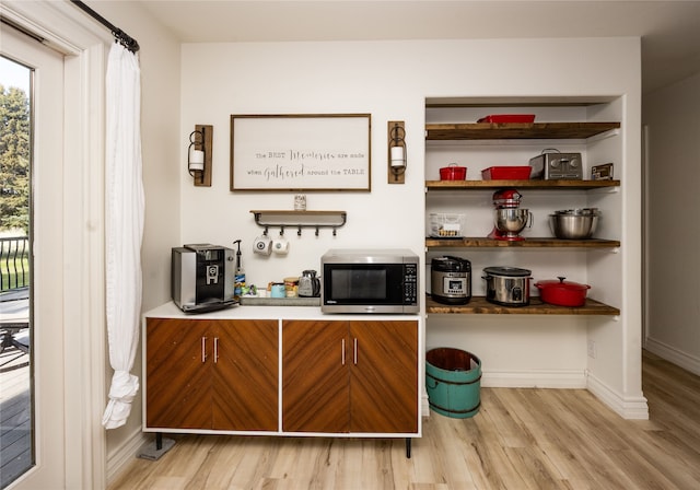 3495 Juniper Dr, Helena, MT 59602 - bar with stainless steel microwave, light wood-type flooring, and baseboards