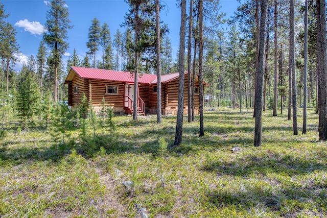 425 S O St, Sula, MT 59871 - view of front of house featuring log siding, metal roof, a standing seam roof, and a wooded view