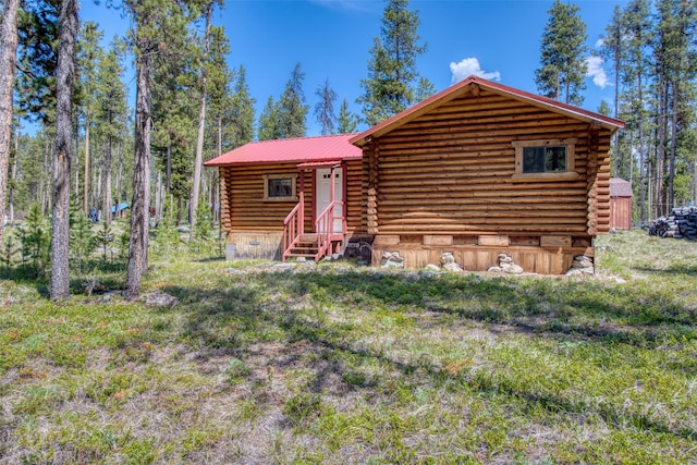 425 S O St, Sula, MT 59871 - back of house featuring log exterior, metal roof, and entry steps