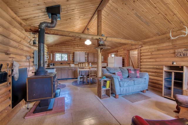 425 S O St, Sula, MT 59871 - living room featuring a wood stove, rustic walls, wooden ceiling, and light flooring