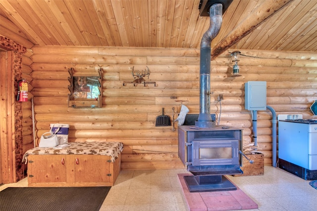 425 S O St, Sula, MT 59871 - detailed view of a wood stove, tile patterned floors, wooden ceiling, a fire extinguisher, and log walls