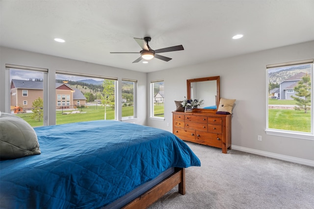 15276 Tyson Way, Frenchtown, MT 59834 - carpeted bedroom with multiple windows, baseboards, recessed lighting, and ceiling fan