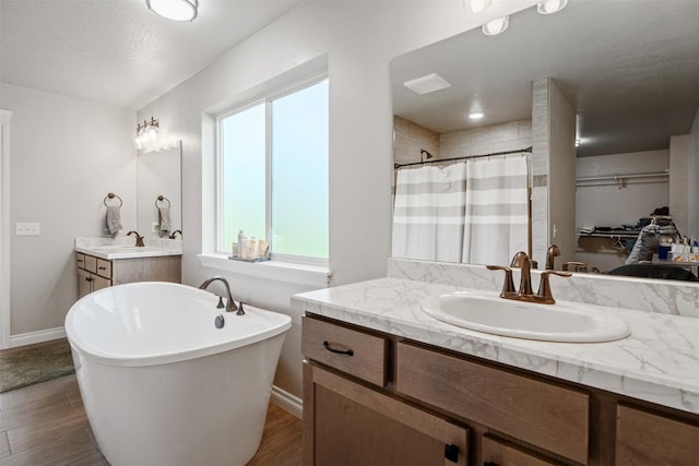 15276 Tyson Way, Frenchtown, MT 59834 - full bathroom with vanity, a freestanding bath, a shower with shower curtain, and wood finished floors