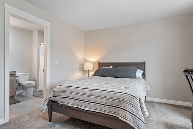 15276 Tyson Way, Frenchtown, MT 59834 - bedroom featuring light carpet, ensuite bath, and baseboards