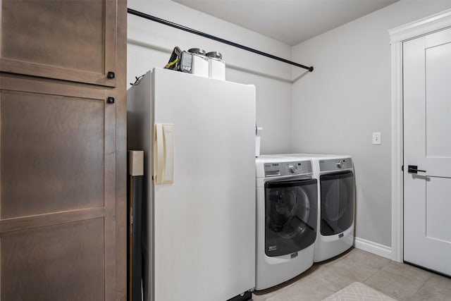 15276 Tyson Way, Frenchtown, MT 59834 - laundry room with washer and clothes dryer, light tile patterned floors, and baseboards