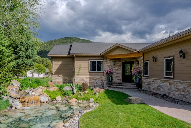 700 Airfield Rd, Libby, MT 59923 - view of front facade featuring stone siding and a front lawn