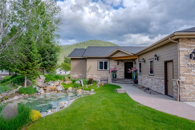 700 Airfield Rd, Libby, MT 59923 - view of front facade with stone siding and a front yard