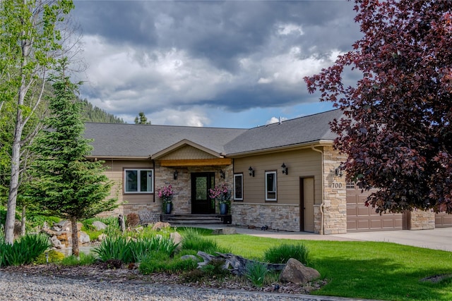 700 Airfield Rd, Libby, MT 59923 - craftsman-style house with stone siding, a garage, driveway, and a shingled roof